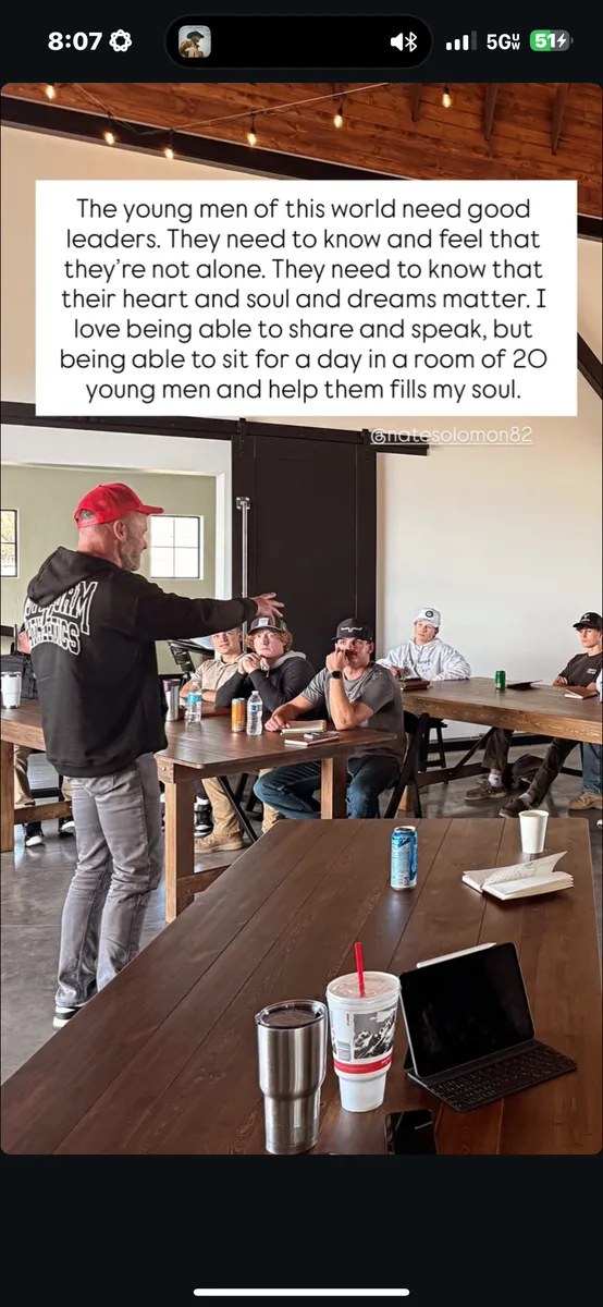 Nate Solomon speaking to a room of young men seated at tables during a RealTalk event