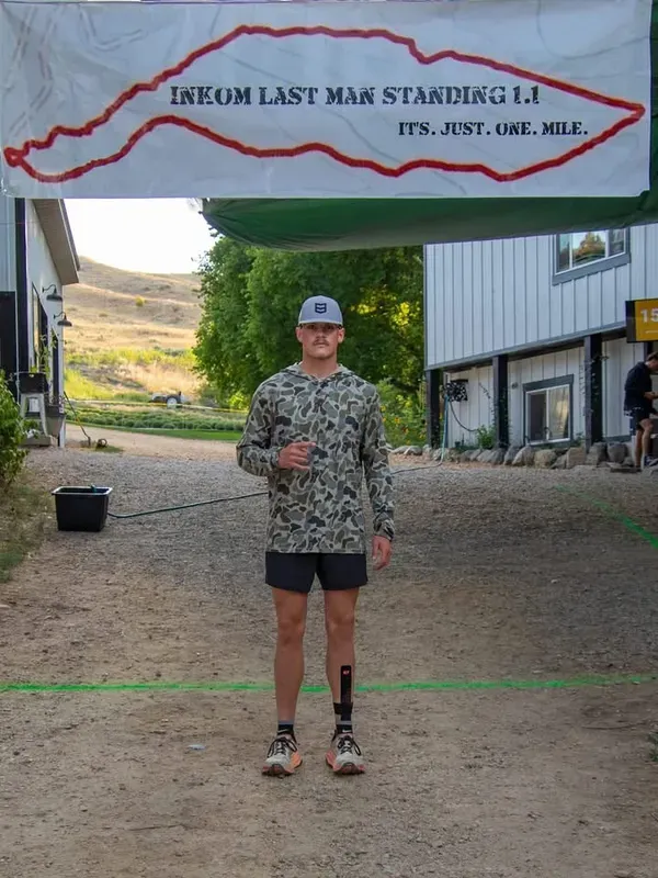 Runner standing at the Inkom Last Man Standing start line in camo hoodie and cap
